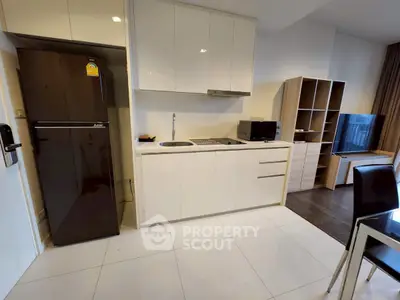 Modern kitchen with sleek cabinetry and integrated appliances in a stylish apartment.