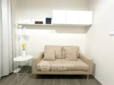 Cozy living room with beige sofa and modern decor, perfect for relaxation.