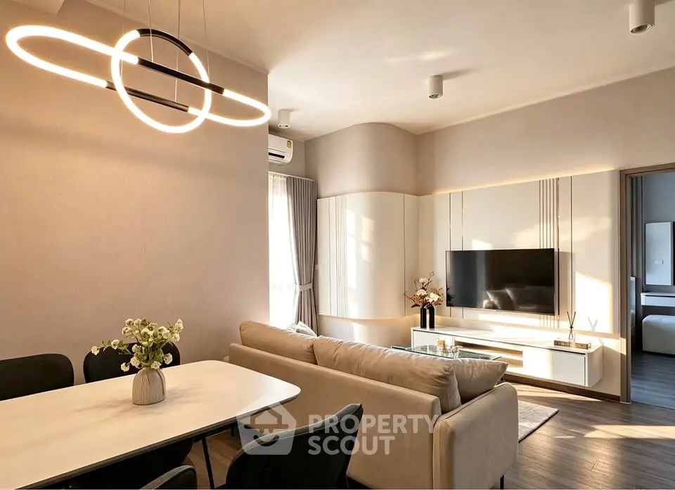 Modern living room with stylish lighting and cozy seating area, perfect for relaxation and entertainment.