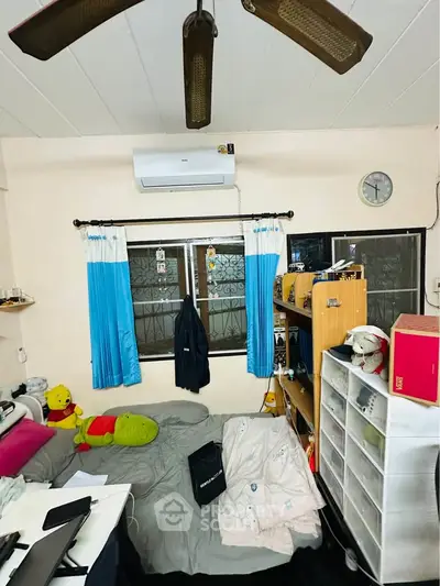 Cozy bedroom with air conditioning and organized storage solutions.