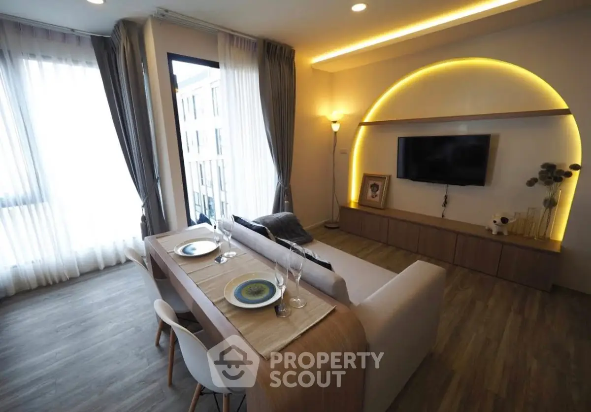 Modern living room with stylish lighting and cozy dining area