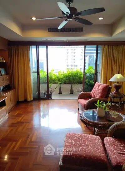 Spacious living room with elegant decor and balcony view in modern apartment.