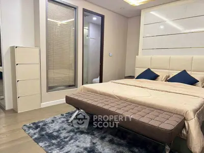 Luxurious bedroom with modern decor and plush bedding in a stylish apartment.