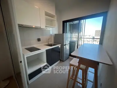 Modern kitchen with sleek design and balcony view