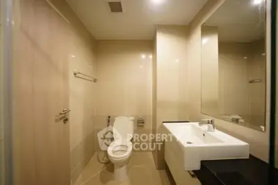 Modern bathroom with sleek fixtures and neutral tiles