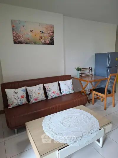 Charming living room with cozy sofa, elegant decor, and modern dining area.