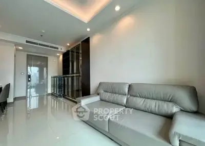Modern living room with sleek leather sofa and elegant lighting in a contemporary apartment.