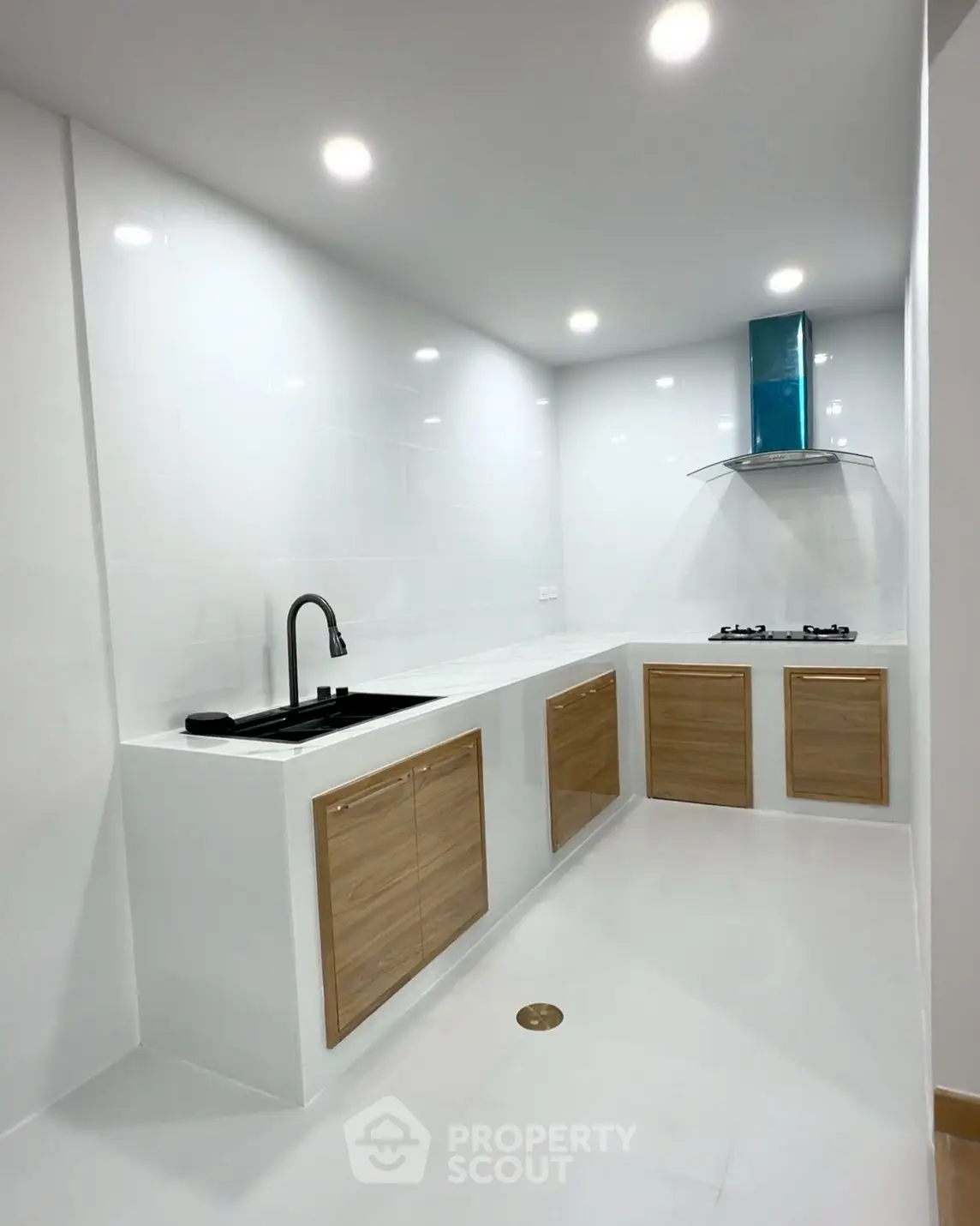 Modern kitchen with sleek white cabinets and gas stove in a minimalist design