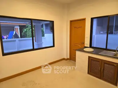Bright kitchen with wooden accents and large windows in modern home