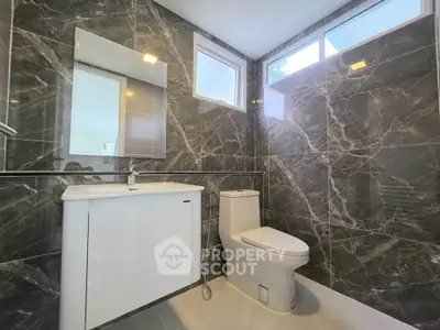 Luxurious modern bathroom with marble walls and sleek fixtures
