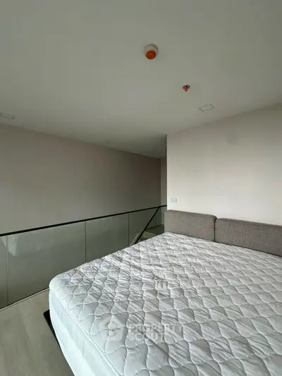 Modern bedroom with minimalist design and glass railing