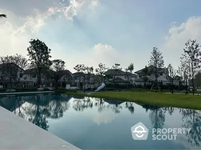 Luxurious residential community with serene pool and lush greenery