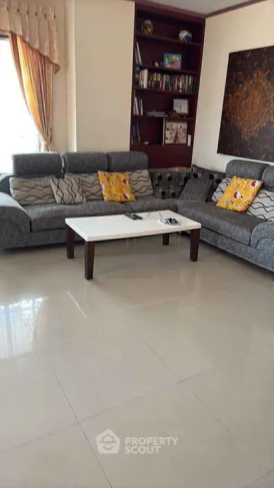 Spacious living room with modern gray sofas and elegant decor