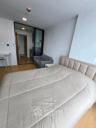 Modern bedroom with cozy bed and stylish decor in a contemporary apartment.