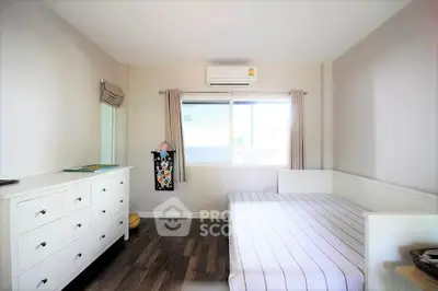 Bright and airy bedroom with modern furnishings and large window