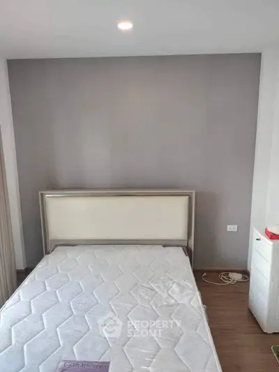 Minimalist bedroom with modern bed frame and wooden flooring