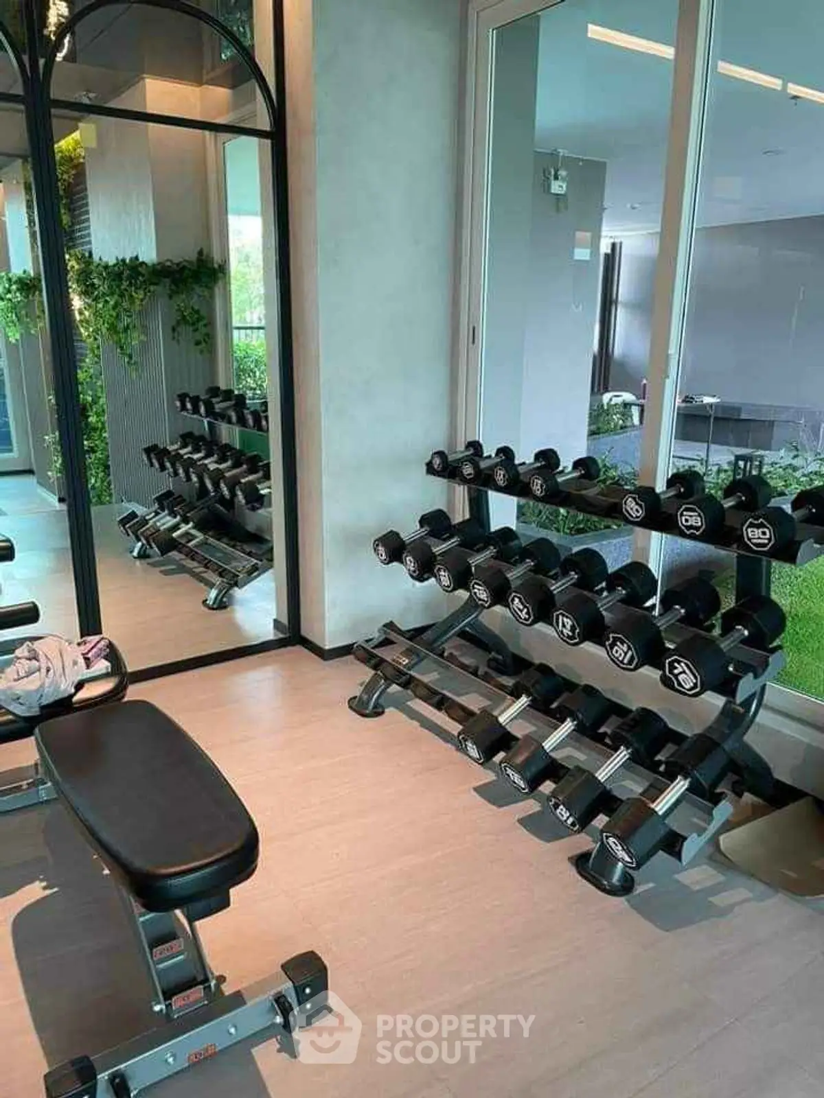 Modern home gym with dumbbells and bench in sleek interior design