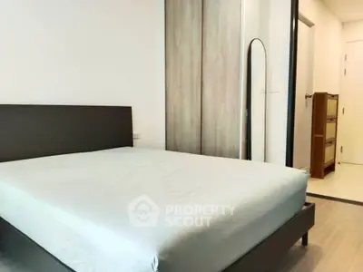 Modern bedroom with minimalist design and sleek wooden furniture.