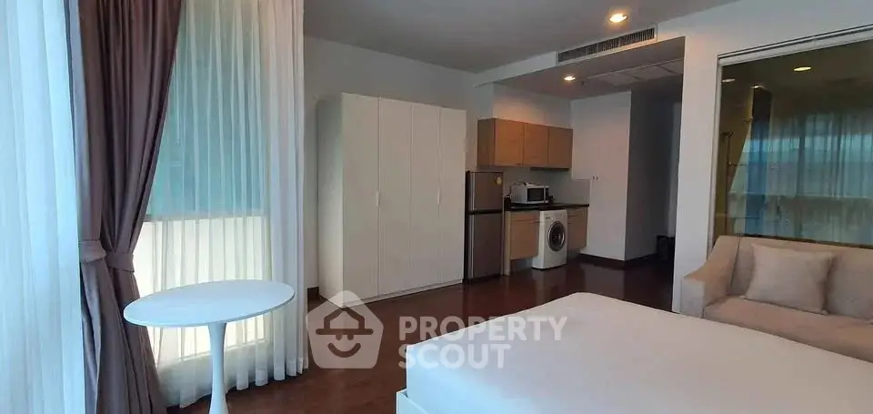 Modern studio apartment with washing machine and cozy living area