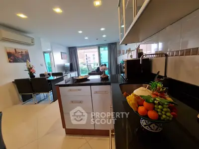 Modern open-layout kitchen and living room with sleek design and natural light.