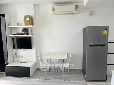 Modern compact living space with sleek furniture and appliances, ideal for urban living.