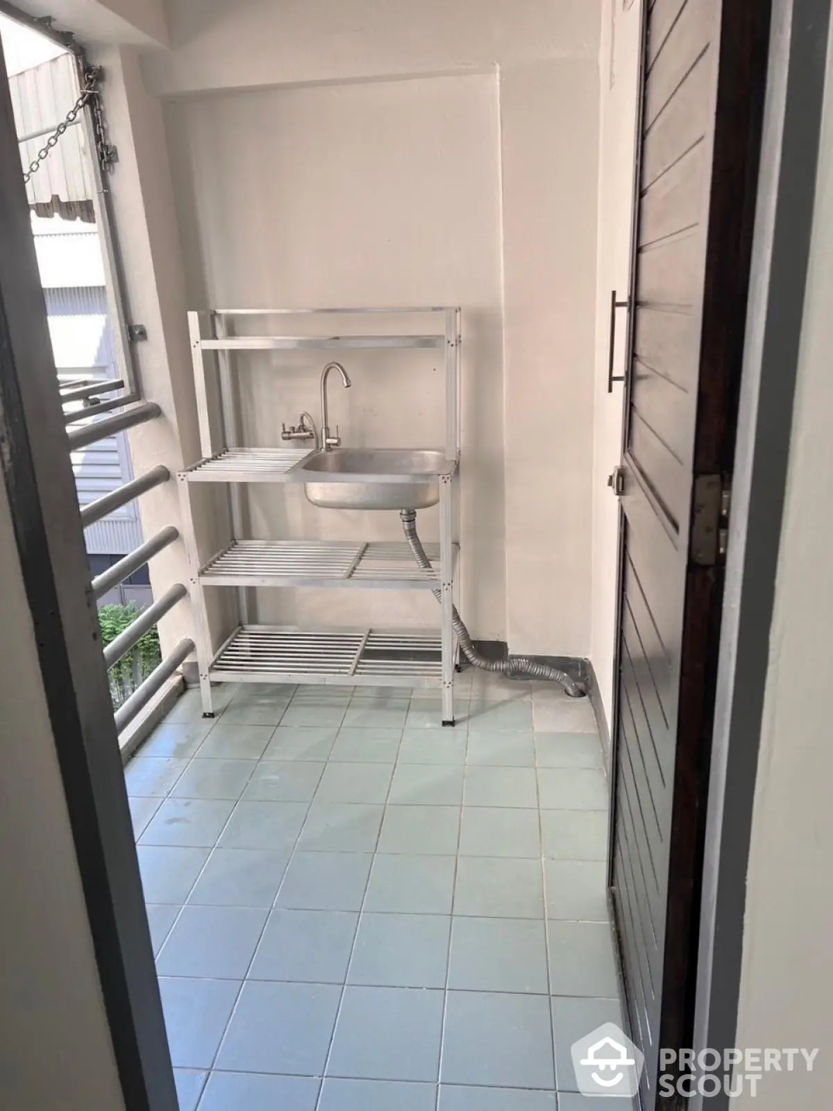 Compact balcony with utility sink and storage shelves