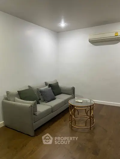 Cozy living room with modern gray sofa and stylish round coffee table.