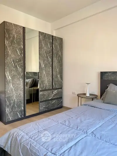 Modern bedroom with stylish wardrobe and cozy bed setup