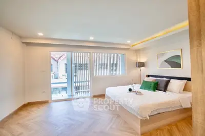 Spacious modern bedroom with large windows and stylish decor