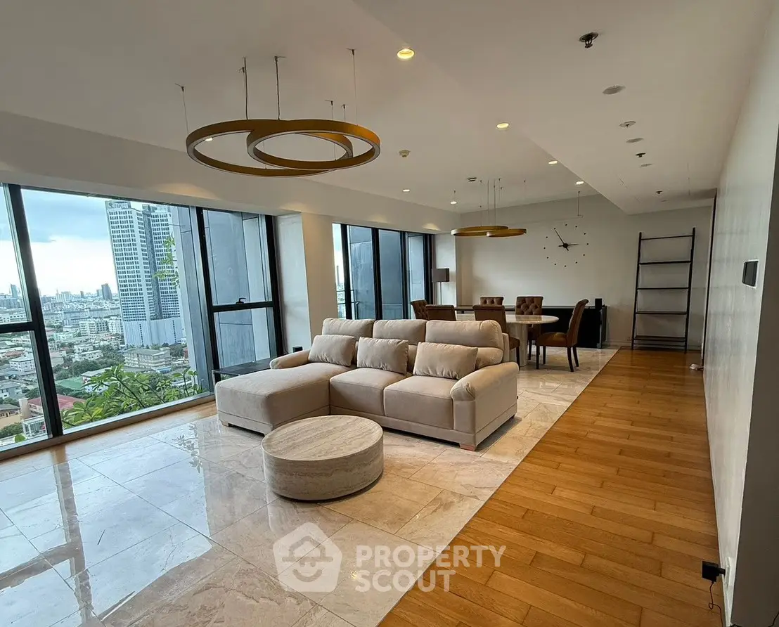 Spacious modern living room with panoramic city views and elegant furnishings.