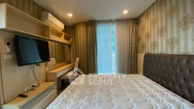 Luxurious bedroom with elegant wallpaper and modern furnishings in a high-end apartment.