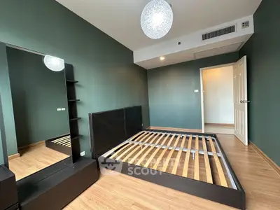 Spacious bedroom with modern design and wooden flooring