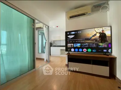 Modern living room with sleek TV and open kitchen in stylish apartment