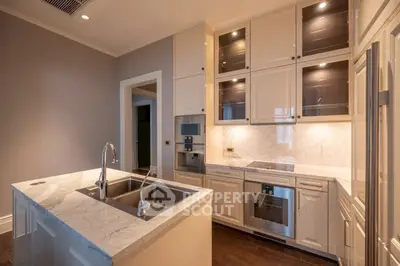 Luxurious modern kitchen with marble countertops and high-end appliances in elegant home.