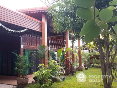 Charming tropical garden view with traditional wooden house exterior