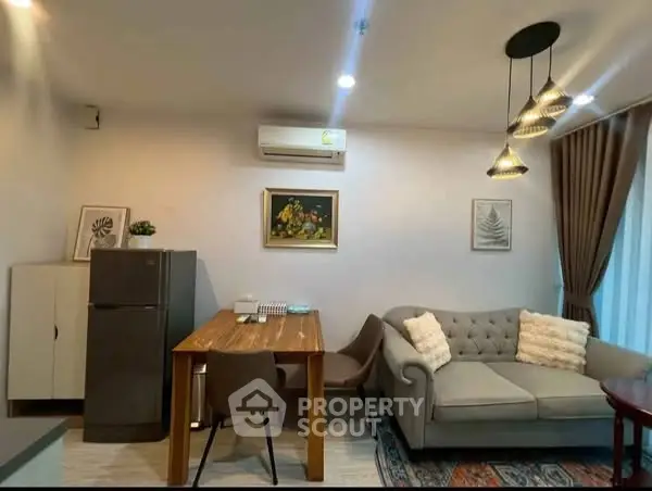 Cozy living room with modern decor, featuring a plush sofa and dining area.
