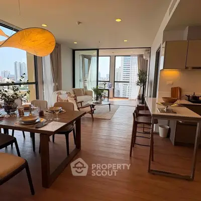 Modern open-plan living room with dining area and city view balcony in luxury apartment