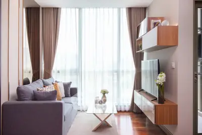 Modern living room with elegant decor and large windows for natural light.