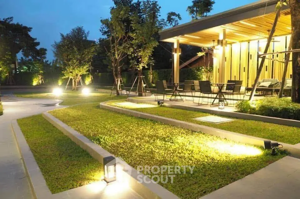 Stunning modern garden with elegant lighting and stylish outdoor seating area.
