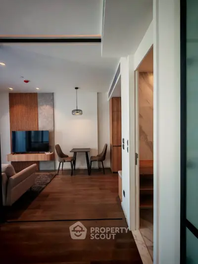 Modern living room with stylish decor and open layout, featuring a cozy seating area and elegant dining space.
