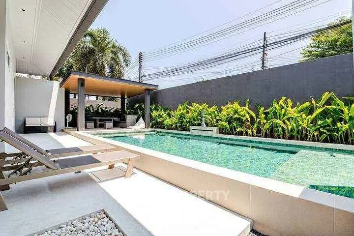 Luxurious modern home with private pool and lush garden, perfect for relaxation and entertainment.