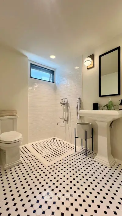 Elegant bathroom with modern fixtures and stylish black-and-white tile flooring