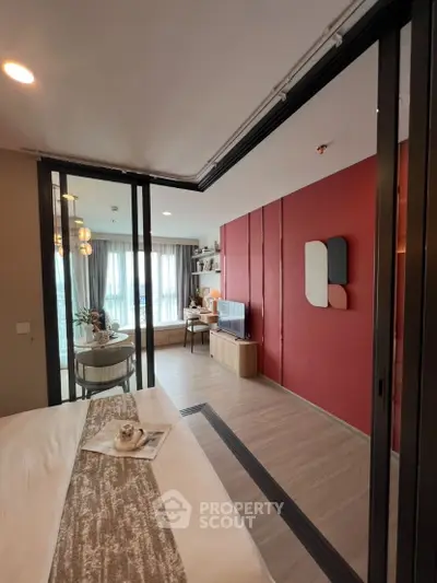 Modern living room with sliding glass doors and stylish red accent wall