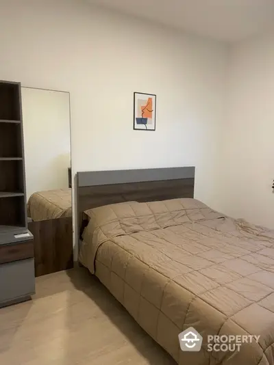 Cozy bedroom with a large comfortable bed, modern wooden headboard, matching bedside shelf, and a minimalist art piece on the wall, perfect for restful nights.