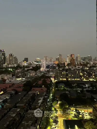 Stunning cityscape view from high-rise apartment at dusk, showcasing vibrant urban skyline.