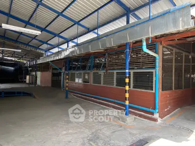 Spacious industrial warehouse with high ceilings and ample natural light.