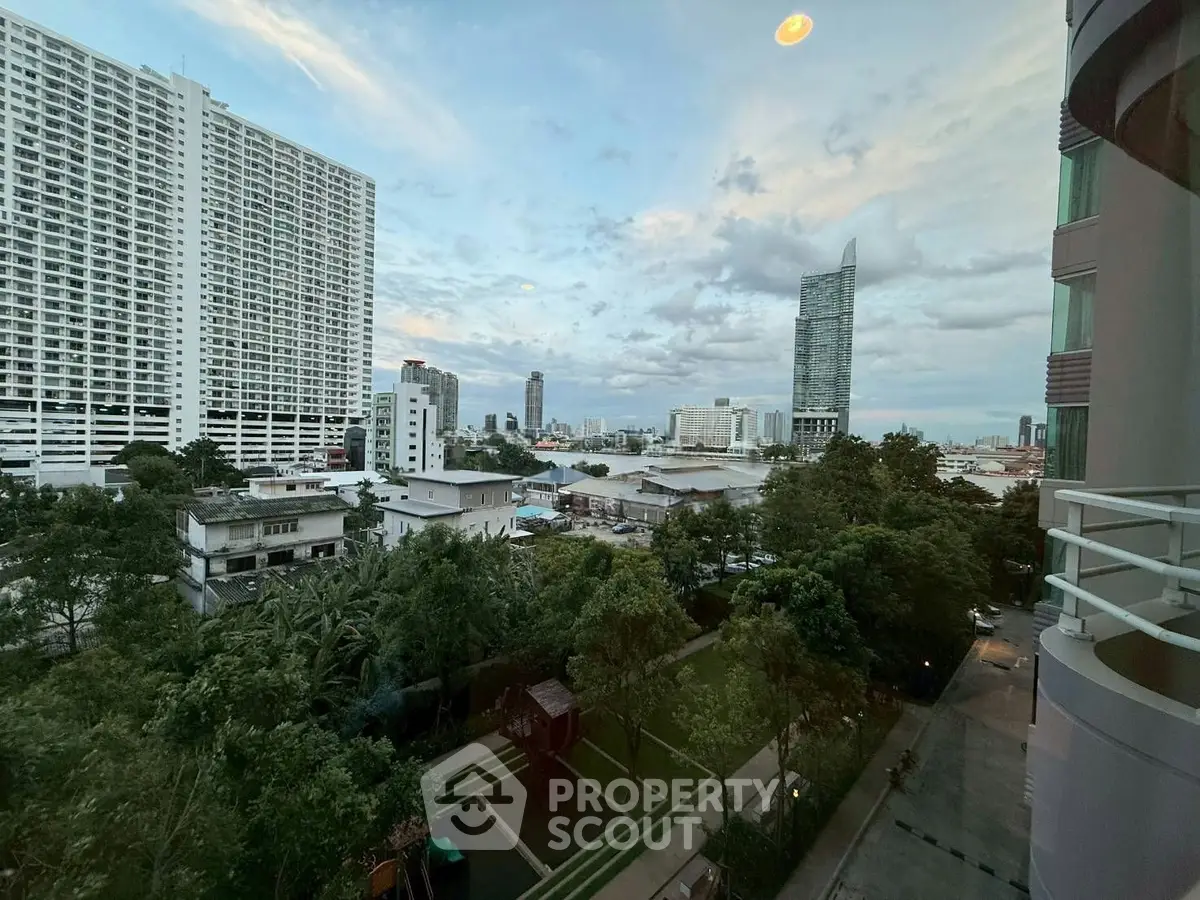 Stunning cityscape view from high-rise balcony overlooking urban skyline and lush greenery.