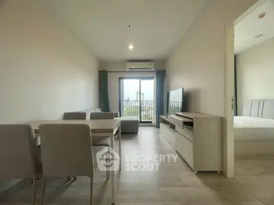 Modern living room with dining area and balcony view in a stylish apartment.