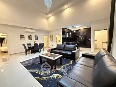 Luxurious open-plan living room with elegant decor and modern kitchen