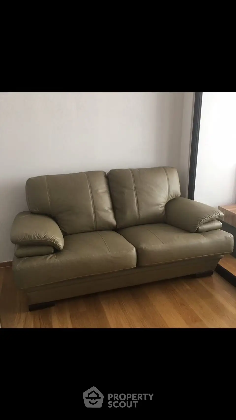 Modern leather sofa in a stylish living room with wooden flooring